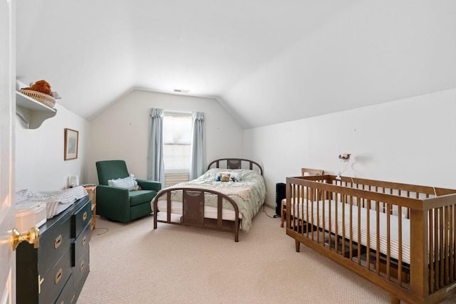 bedroom featuring light carpet, visible vents, and vaulted ceiling