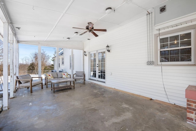 unfurnished sunroom with a ceiling fan