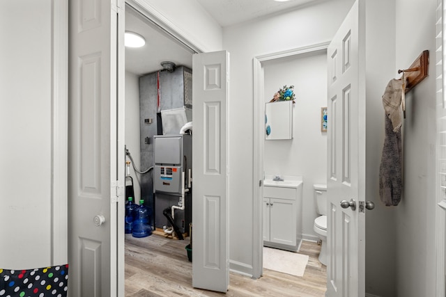 bathroom with toilet, vanity, and hardwood / wood-style floors