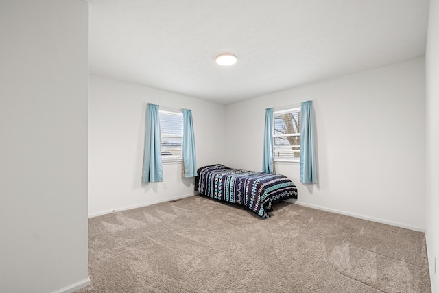 carpeted bedroom with multiple windows