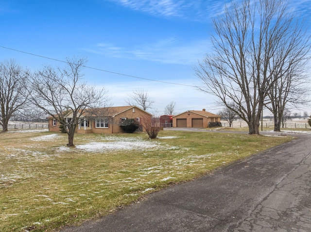 ranch-style house with a front lawn and a garage