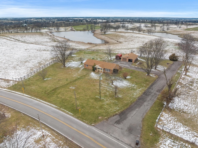 snowy aerial view featuring a water view