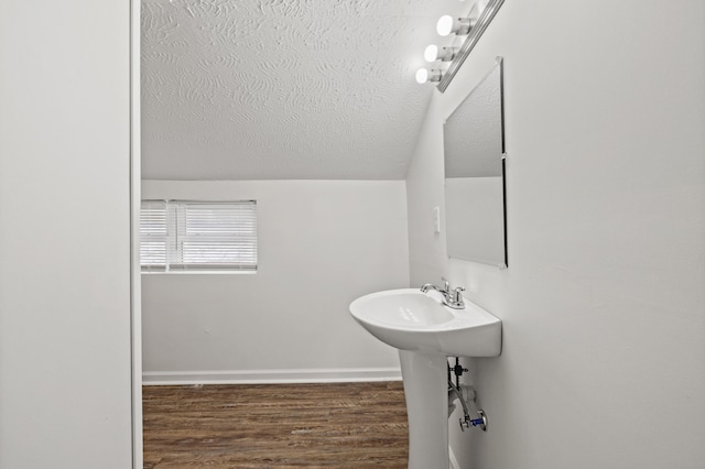 bathroom featuring hardwood / wood-style flooring, sink, and a textured ceiling