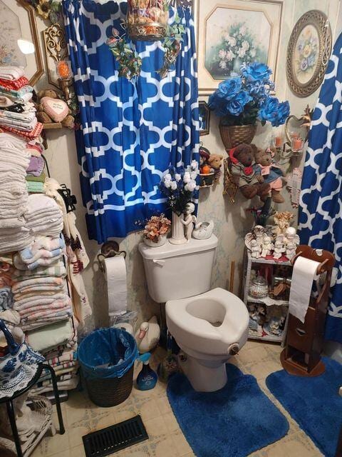 bathroom featuring visible vents and toilet