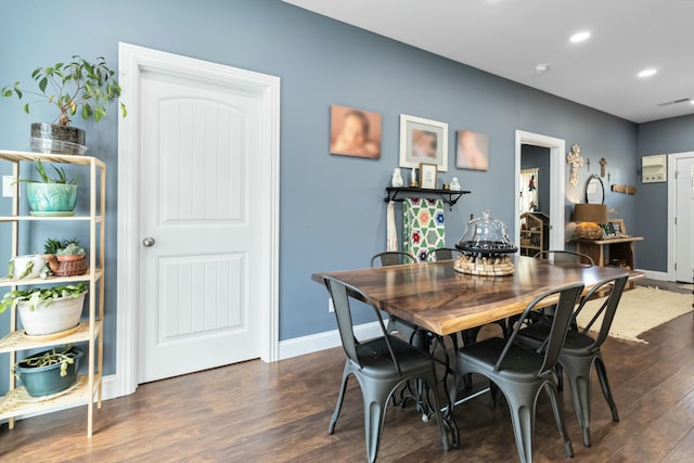 dining area with dark hardwood / wood-style floors