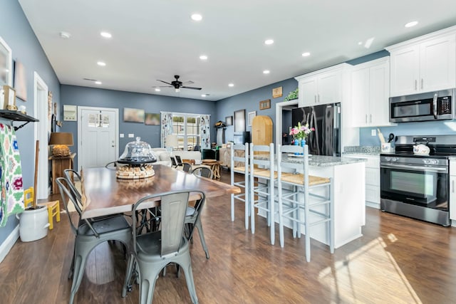 dining space with ceiling fan and hardwood / wood-style floors