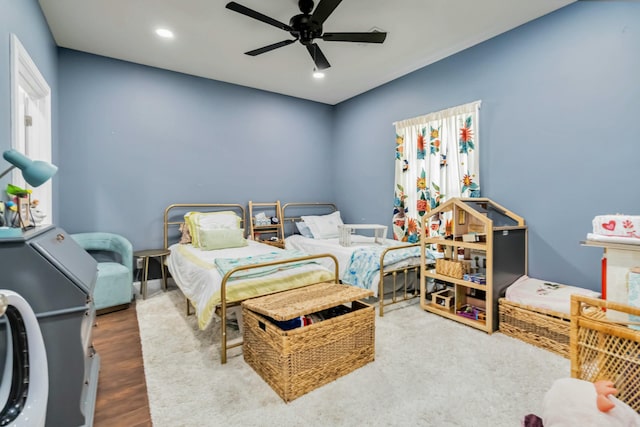 bedroom with hardwood / wood-style floors, multiple windows, and ceiling fan