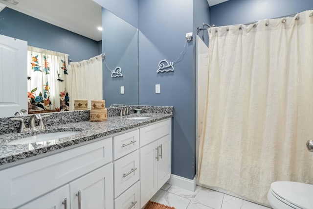 bathroom featuring toilet, vanity, and walk in shower