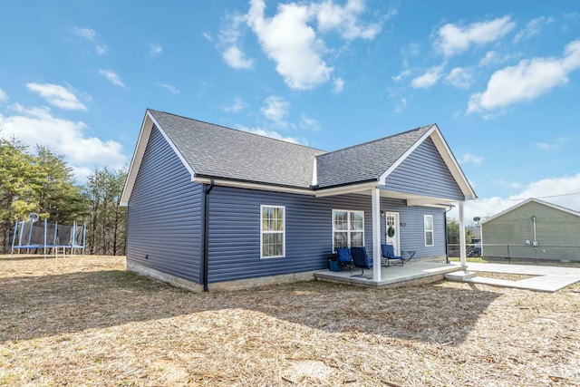 view of front of property with a trampoline and a patio area