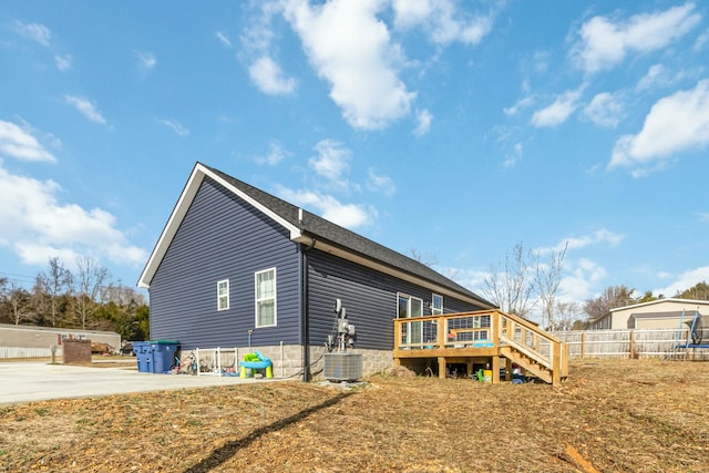 back of property featuring central AC unit, a patio, and a wooden deck