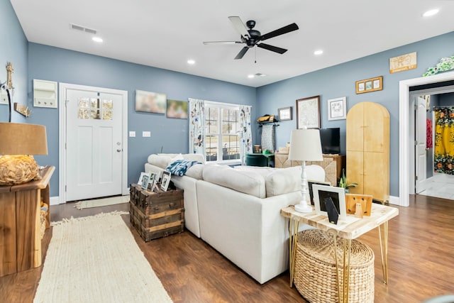 living room with dark wood-type flooring and ceiling fan