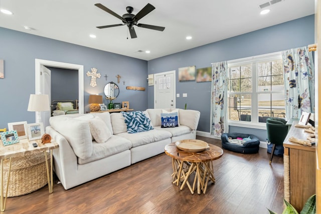 living room with ceiling fan and dark wood-type flooring