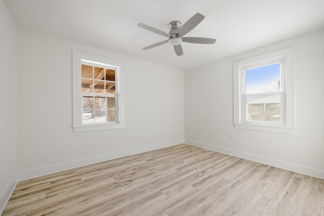 empty room with ceiling fan and light hardwood / wood-style floors