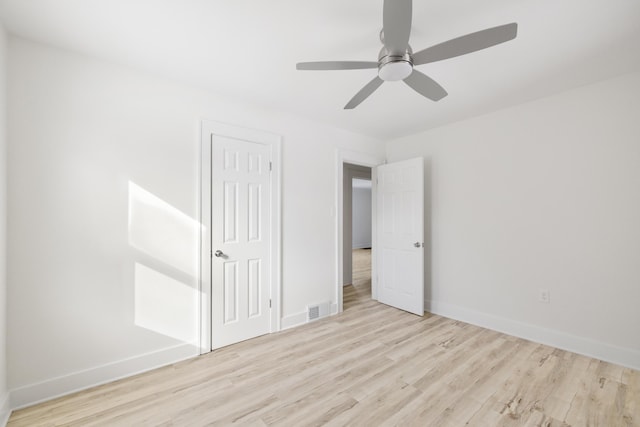 unfurnished bedroom with ceiling fan, a closet, and light hardwood / wood-style floors