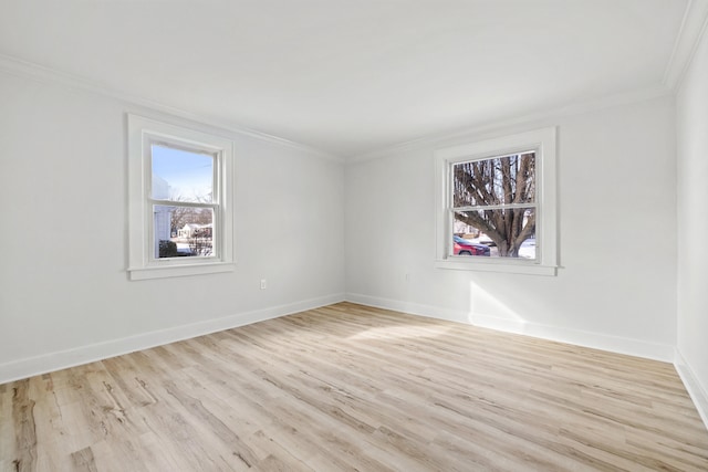 empty room featuring light hardwood / wood-style floors and crown molding