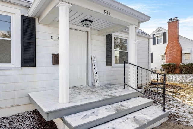 view of snow covered property entrance