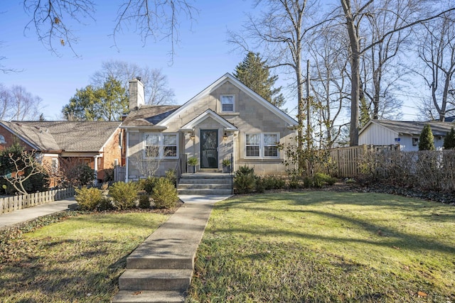 bungalow-style home featuring a front lawn