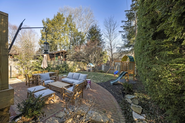 view of patio featuring a playground and outdoor lounge area