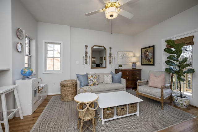 living room with ceiling fan and light hardwood / wood-style flooring