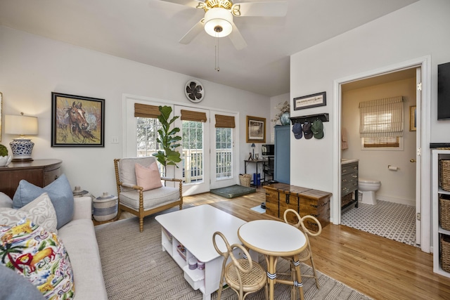 living room featuring ceiling fan and light hardwood / wood-style flooring