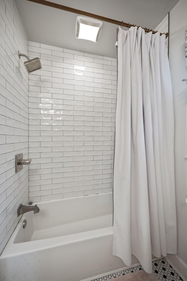 bathroom with shower / bath combination with curtain