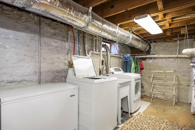 clothes washing area featuring washer and dryer