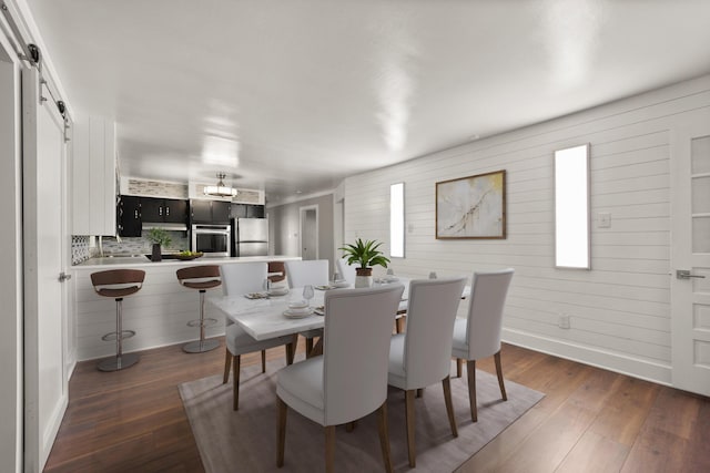 dining space with wood finished floors and baseboards