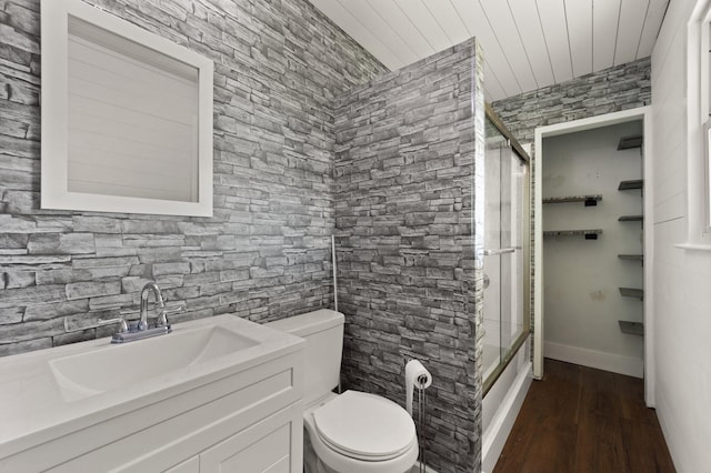 bathroom with vanity, wood finished floors, an enclosed shower, and toilet