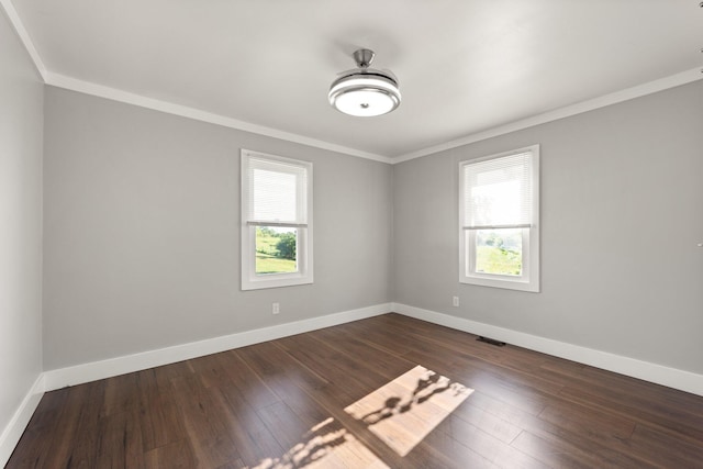 unfurnished room with dark wood-style floors, baseboards, and visible vents