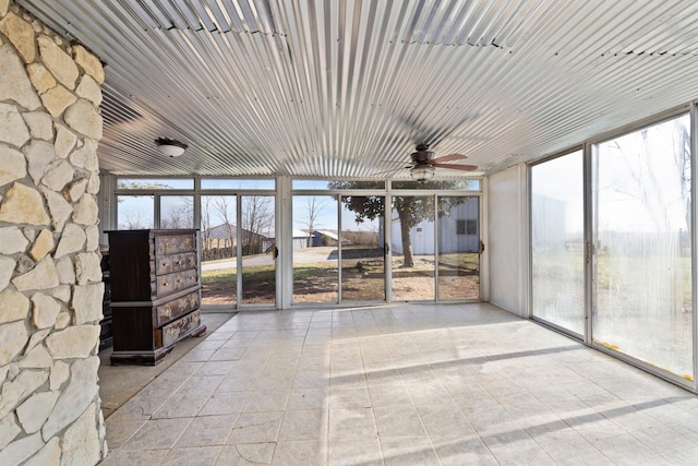 unfurnished sunroom featuring a ceiling fan