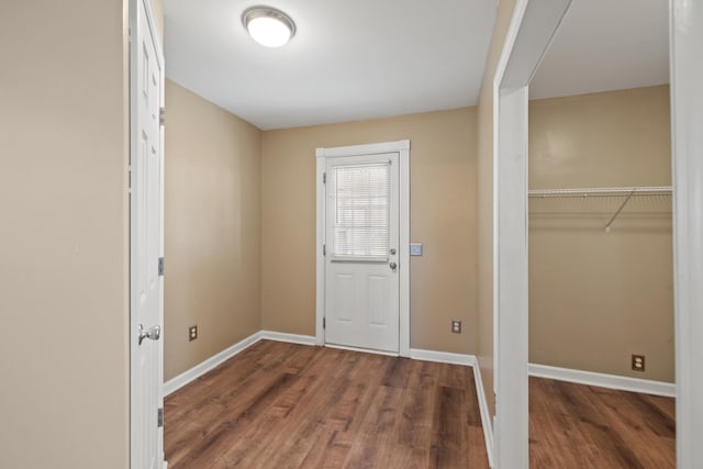 entryway featuring baseboards and wood finished floors