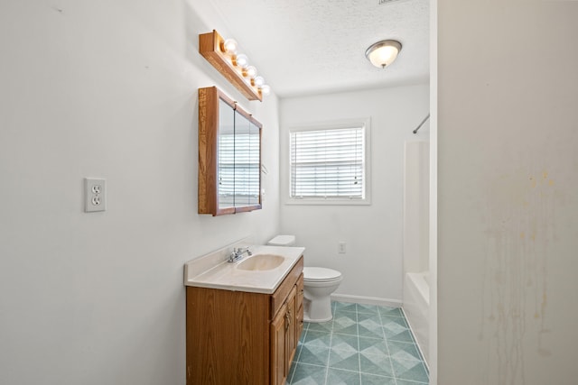 bathroom featuring shower / bathtub combination, toilet, vanity, a textured ceiling, and baseboards