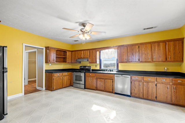 kitchen with open shelves, appliances with stainless steel finishes, dark countertops, and under cabinet range hood