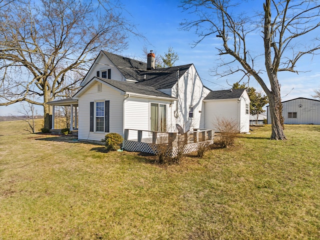 view of home's exterior with a yard, a chimney, and a wooden deck