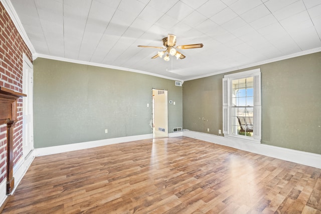 interior space featuring ornamental molding, baseboards, and wood finished floors