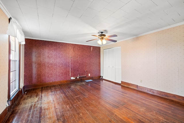 unfurnished room with dark wood-style floors, ceiling fan, ornamental molding, and baseboards