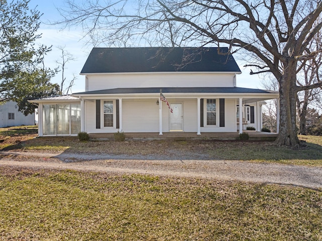 farmhouse inspired home with covered porch and a front lawn