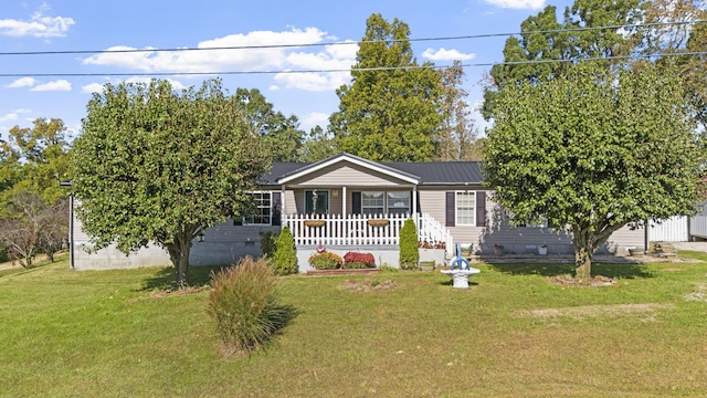 view of front facade featuring crawl space, covered porch, metal roof, and a front lawn