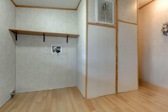 washroom with washer hookup, visible vents, ornamental molding, light wood-type flooring, and laundry area