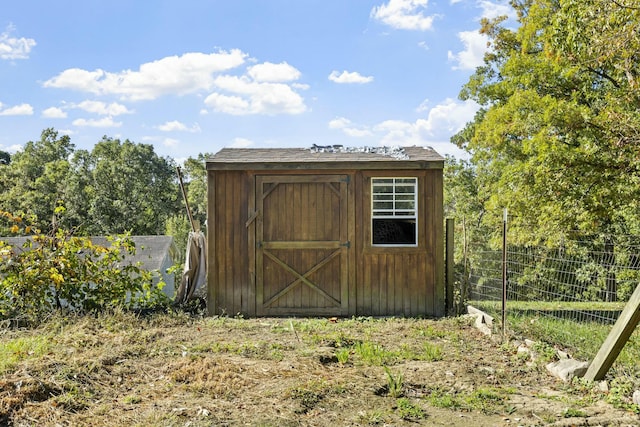 view of shed with fence