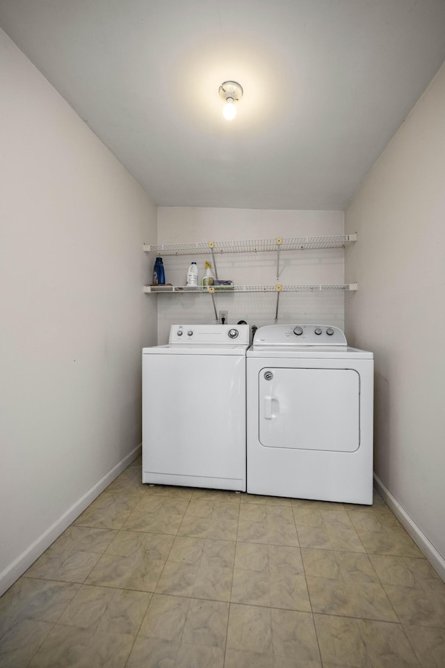 washroom with laundry area, baseboards, and separate washer and dryer