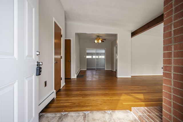 foyer featuring dark wood-style floors, a baseboard heating unit, a ceiling fan, beamed ceiling, and baseboards