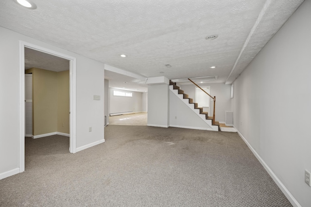 below grade area featuring carpet floors, a textured ceiling, baseboards, and stairs