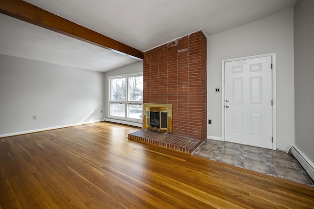 unfurnished living room with a baseboard radiator, a brick fireplace, baseboards, and wood finished floors