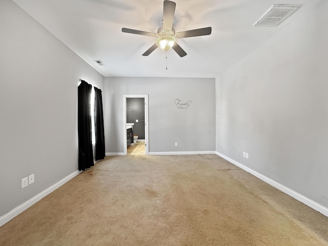 unfurnished room with light carpet, ceiling fan, visible vents, and baseboards