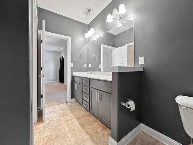 bathroom with toilet, visible vents, baseboards, and vanity