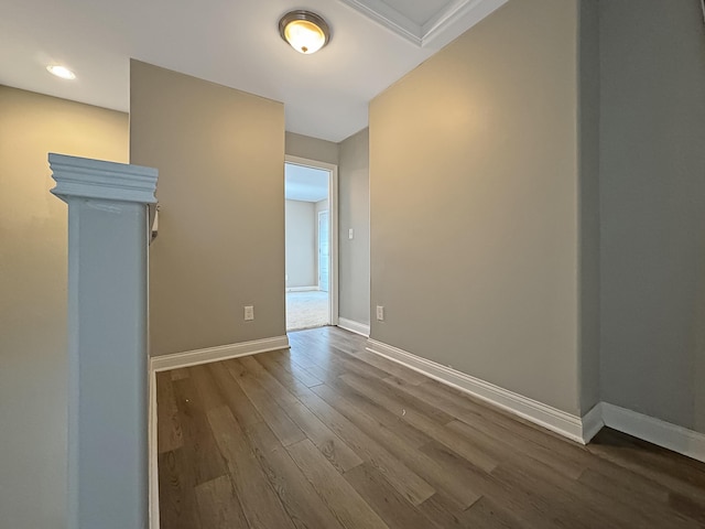 spare room featuring wood finished floors and baseboards