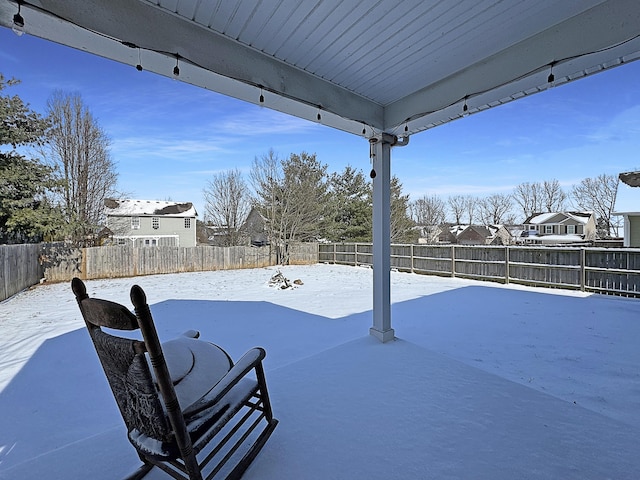 yard layered in snow featuring a fenced backyard