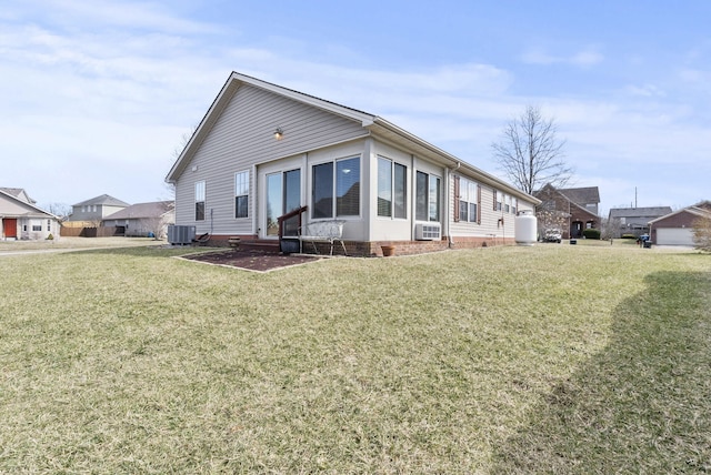 view of front of property with a front yard and central air condition unit