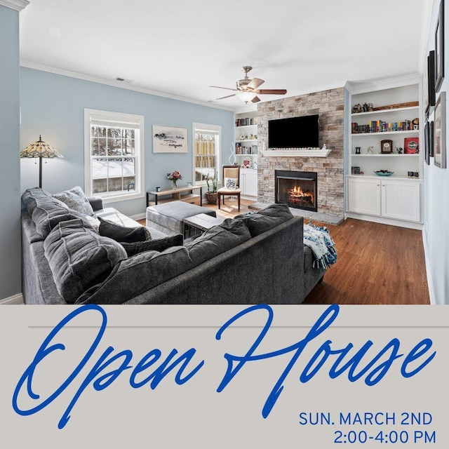 living area featuring built in features, crown molding, visible vents, a stone fireplace, and wood finished floors